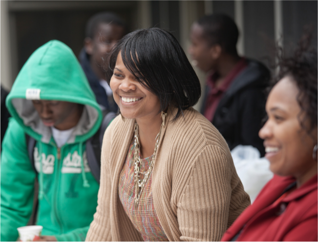 Faculty member and students smiling