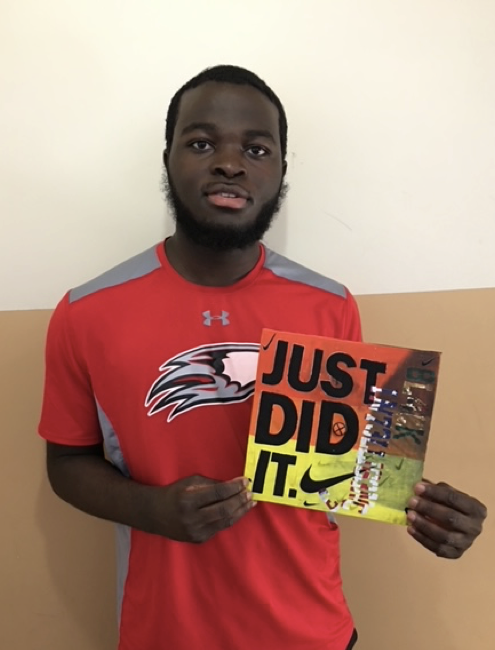 Student holding a "Just did it" sign