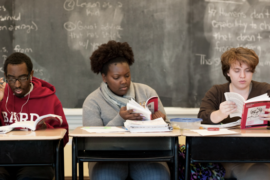 Three students reading in class