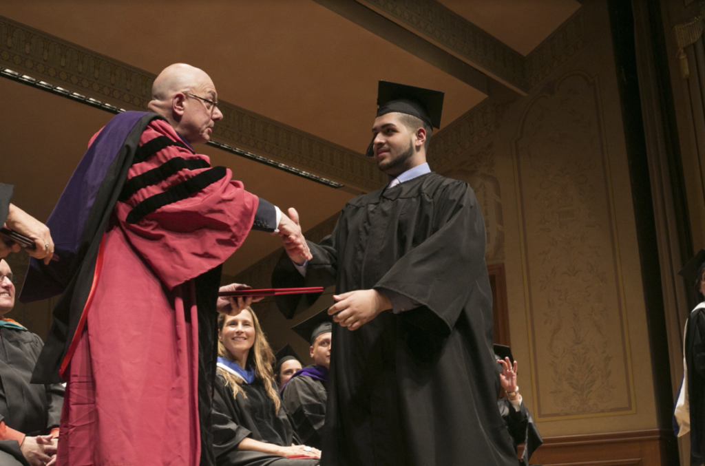 Student receiving diploma on graduation day