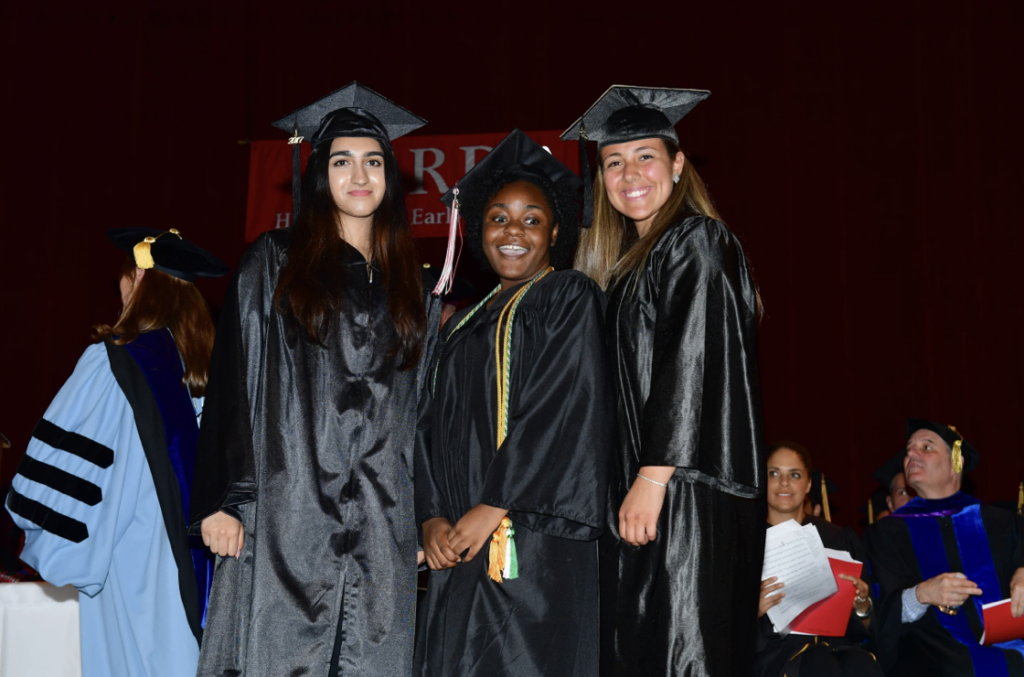 Photo of three students at graduation